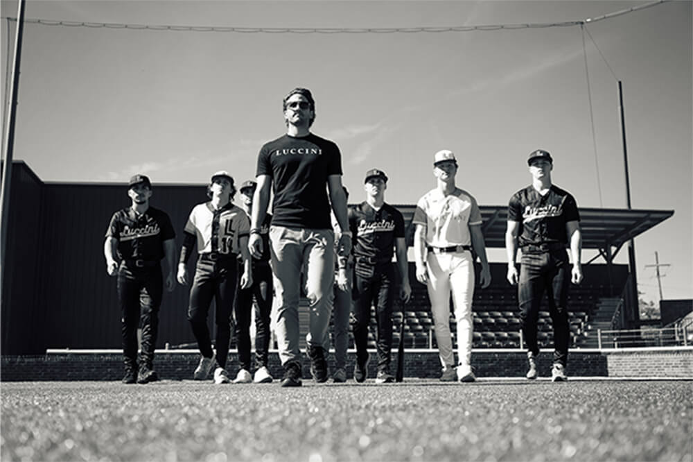 An image of Gavin walking with Luccini baseball players.